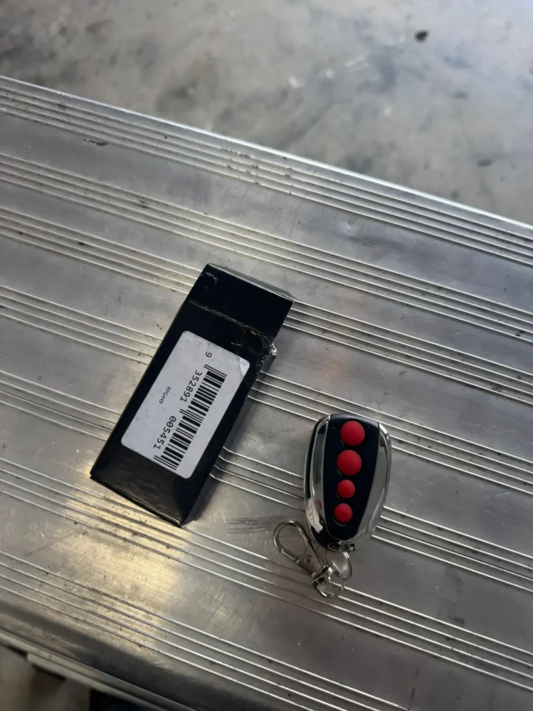 Garage door remote placed on a ladder